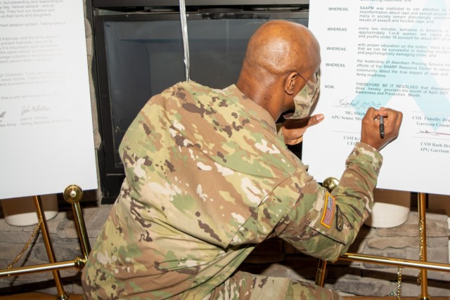 APG Senior Commander Maj. Gen. Mitchell Kilgo signs a proclamation acknowledging April as Sexual Assault Awareness and Prevention Month at APG.