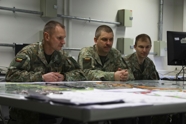Lithuanian soldiers assigned to the Lithuanian Land Forces listen to a brief from U.S. Army Warrant Officer Benhur Rodriguez, 4th Infantry Division Counterfire Officer, during the Joint Multinational Simulation Center hosted, Allied Spirit 23 Command Post Exercise 1 for U.S and multinational forces March 7, 2023 on Camp Aachen at the Grafenwoehr Training Area, Germany. The Allied Spirit 23 CPX 1 is a command post exercise for V Corps with participation of two multinational divisions elements, the Polish 12th Mechanized Division and Lithuanian Mission Command Element, in preparation for V Corps’ Warfighter Exercise (WFX). 