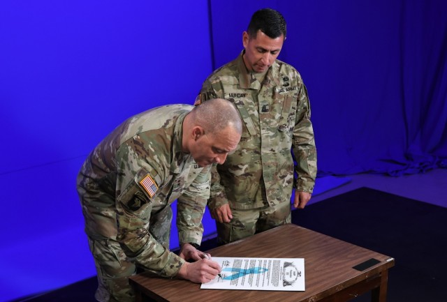 Commander of U.S. Army Recruiting Command and Fort Knox Maj. Gen. Johnny Davis and USAREC Command Sgt. Maj. Shade Munday sign the annual Sexual Assault Awareness and Prevention Month Proclamation March 16, 2023.