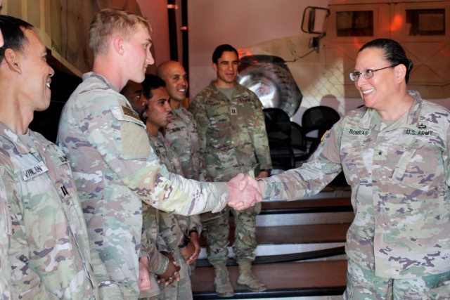 Brig. Gen. Aida Borras, Assistant Deputy Chief of Staff, Army G2 in the Pentagon, congratulating the 325th Brigade Support Battalion Top Gun Crew that provided a presentation on mounted crew qualifications to the visiting foreign military attachés and their spouses, March 9, 2023.