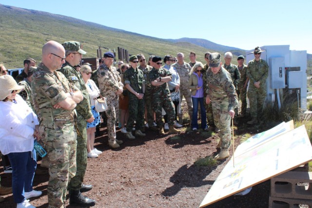 U.S. Army Garrison Pōhakuloa Training Area Garrison (PTA) Commander Lt. Col. Kevin Cronin briefing foreign military attachés and their spouses on the garrison mission and capabilities at Pu’u Pōhakuloa with Mauna Kea in backdrop, March 9, 2023.