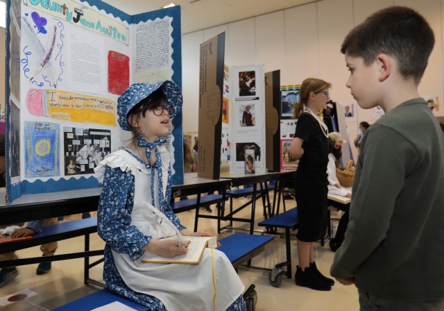 Trinity Hatfield, a fourth grader at Arnn Elementary School, portrays Jane Austen during a living wax museum event in the school&#39;s cafeteria at Sagamihara Family Housing Area, Japan, March 17, 2023. More than 60 fourth graders participated in the event, which highlighted change makers from athletes, artists and authors to inventors, politicians, royalty and other trailblazers.