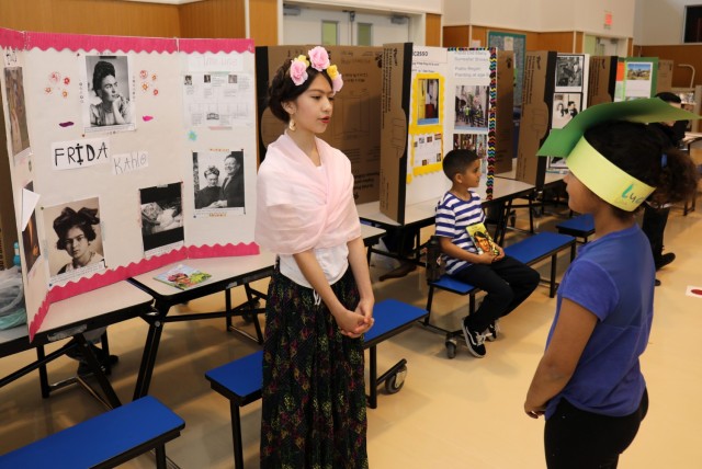 Naomi Ramos, a fourth grader at Arnn Elementary School, portrays Frida Kahlo during a living wax museum event in the school&#39;s cafeteria at Sagamihara Family Housing Area, Japan, March 17, 2023. More than 60 fourth graders participated in the event, which highlighted change makers from athletes, artists and authors to inventors, politicians, royalty and other trailblazers.