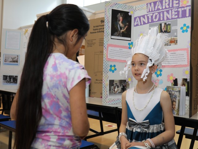 Hailey Martin, a fourth grader at Arnn Elementary School, portrays Marie Antoinette during a living wax museum event in the school&#39;s cafeteria at Sagamihara Family Housing Area, Japan, March 17, 2023. More than 60 fourth graders participated in the event, which highlighted change makers from athletes, artists and authors to inventors, politicians, royalty and other trailblazers.