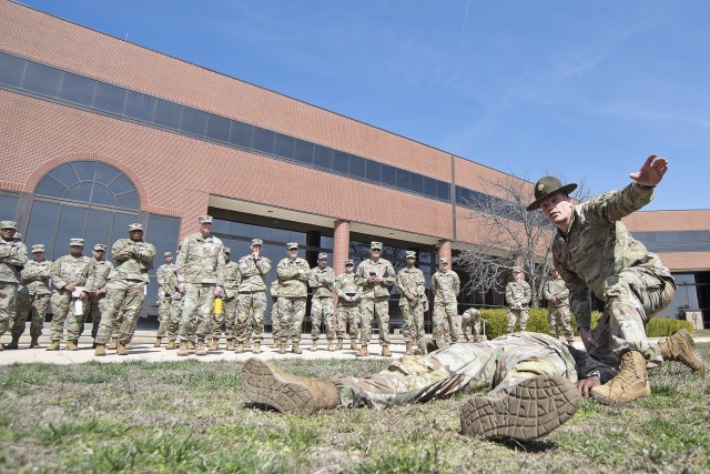 Staff Sgt. Timothy Genz, a drill sergeant with the 169th Engineer Battalion, reacts to a Soldier with a simulated heat injury on Monday on the Maneuver Support Center of Excellence Plaza during the installation’s heat injury prevention...