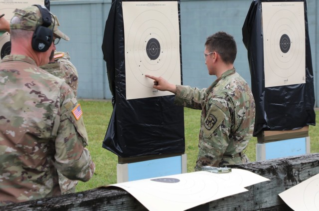a competitor inspects his target during the 2023 U.S. Army Small Arms Championship at Fort Benning, GA. Mar. 17, 2023. 260 Soldiers of all components competed for titles and bragging rights in the 2023 U.S. Army Small Arms Championships March...