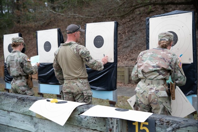 Cadets Hayle and Jesse Mayer, with Texas A&M Reserve Officers&#39; Training Corps, score targets in the Bullseye Pistol Match.