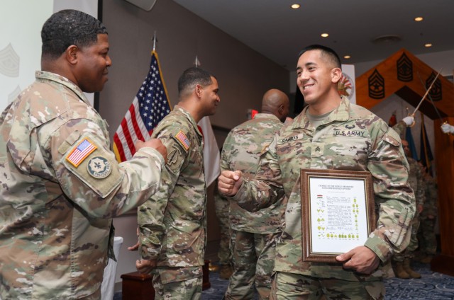 Sgt. Alejandro Ramos, assigned to the 78th Signal Battalion, is congratulated by senior noncommissioned officers after being inducted into the NCO corps during a ceremony at the Camp Zama Community Club, Japan, March 22, 2023. Nearly 20 NCOs participated in the ceremony, which was hosted by the 78th Sig. Bn. and U.S. Army Aviation Battalion Japan.