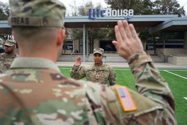 Capt. Michael S. Freas and Staff Sgt. Alexis Seales recite the oath of enlistment during a re-enlistment ceremony at the AT&T Stadium Feb. 24. Staff Sgt. Alexis Seales is a Dallas naïve and a lifelong Cowboys fan, so she decided to re-enlist at...