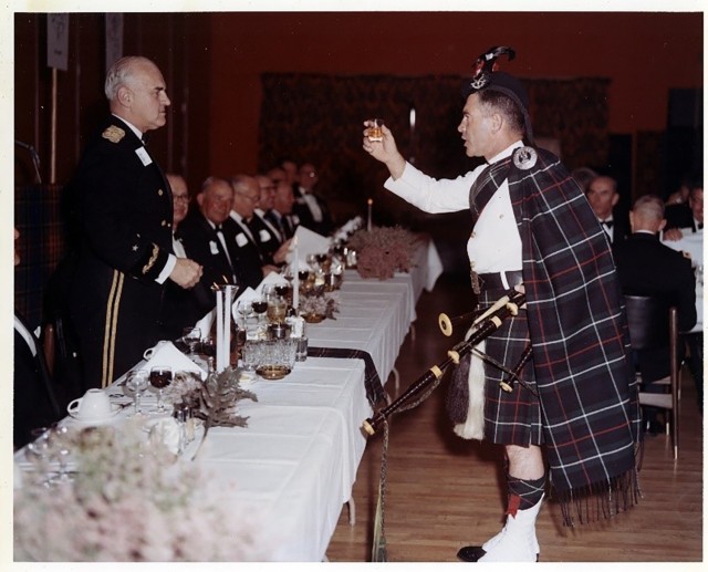 The pipe major of the 1st Salinas Valley Highlanders offers a toast to Maj. Gen. Robert G. Ferguson, commander of Fort Ord, at a Burn’s Night supper on Jan. 25, 1967.