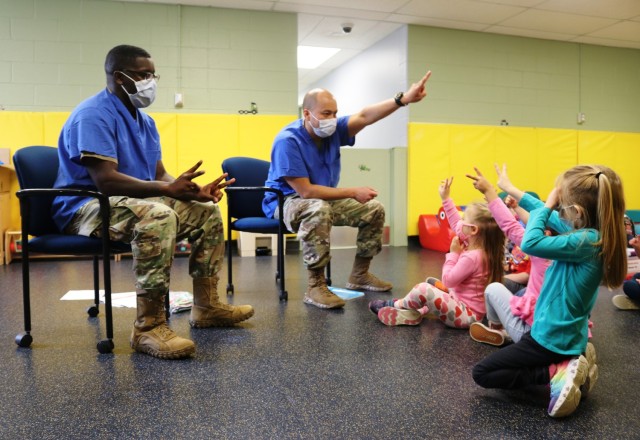 Soldiers discuss dental health with children