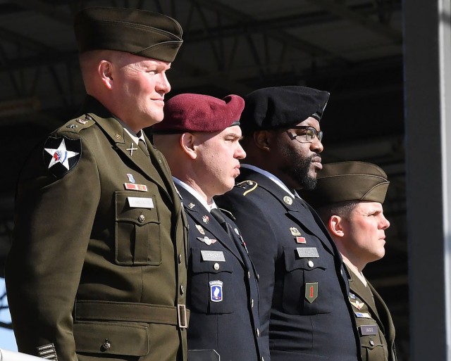 (Left to right) Lt. Col. Derek Campbell, 2nd Battalion, 13th Infantry Regiment commander; Chief Warrant Officer 2 Ryan Treat; Staff Sgt. Trevor Ward; and Command Sgt. Maj. Joseph Magni, 2-13th senior enlisted advisor, stand at attention during the...