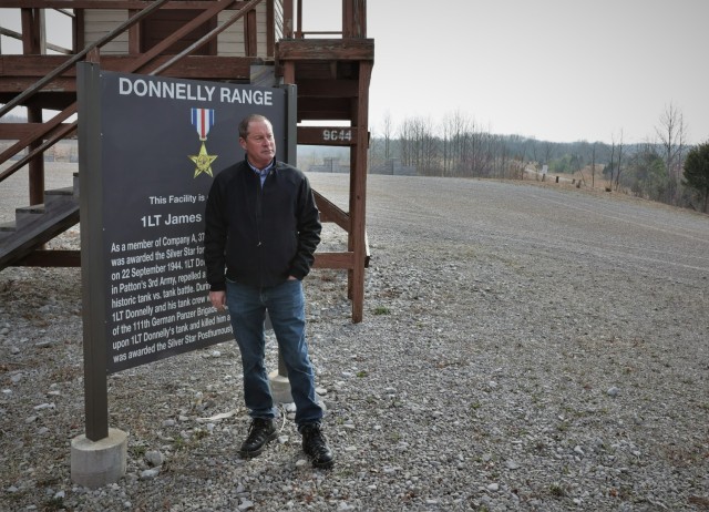 James Donnelly of the Denver area stands beside the sign for Donnelly Range March 28, 2023, named for his uncle who was killed in action during World War II.