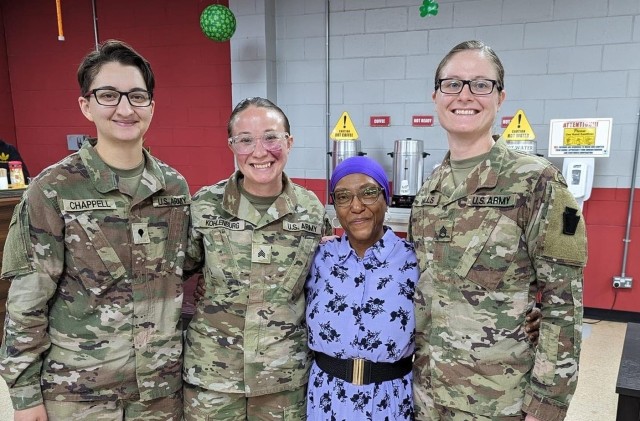 28th Infantry Division Soldiers posing with a Women&#39;s Army Corps veteran at the Women&#39;s History Month celebration