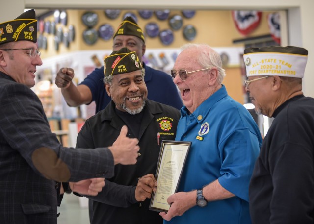 Army and Air Force Exchange Service employees, along with members of the Veterans of Foreign Wars Post 3176, present Jim Ashby, a retired Air Force Vietnam War veteran, a lapel pin and framed copy of the presidential proclamation commemorating the...