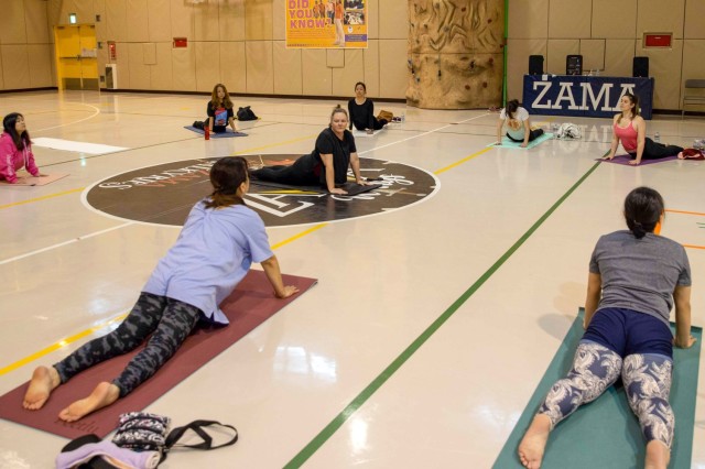 Terry Owens, center, leads a meditation and yoga session at the Camp Zama Youth Center gym as part of a Women&#39;s History Month celebration at Camp Zama, Japan, March 27, 2023. The Camp Zama community celebrated the observance with a week of various events to highlight and empower women on the installation.