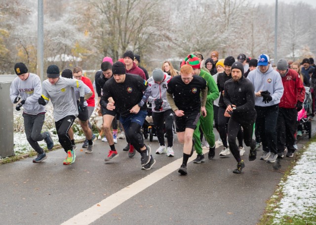 U.S. Army Soldiers assigned to Task Force Orion, 27th Infantry Brigade Combat Team, New York Army National Guard, run alongside Soldiers, civilians and family members in a 5K 