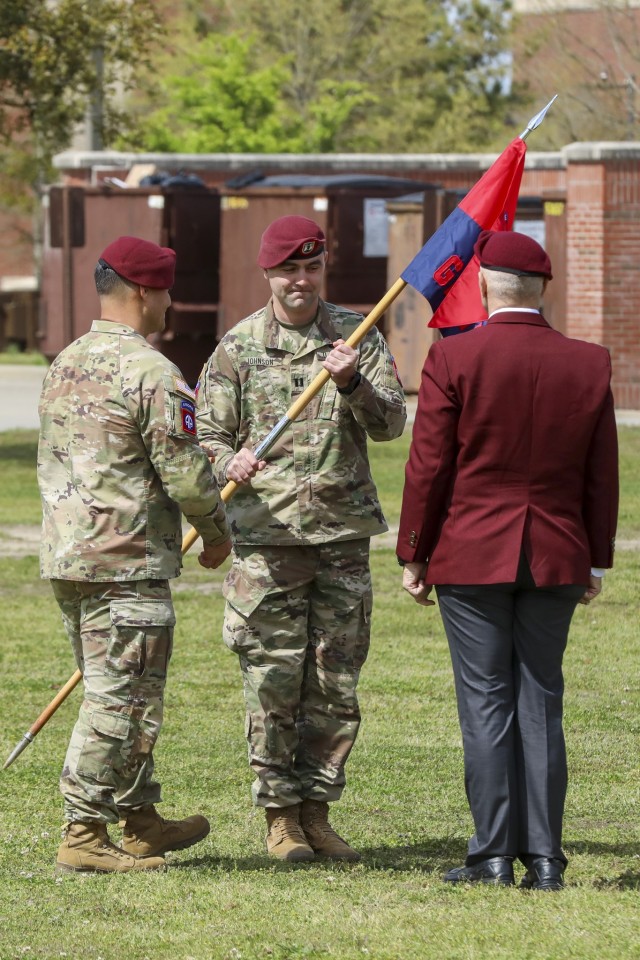 Lt. Col. Leif Thaxton, commander of Headquarters and Headquarters Battalion, 82nd Airborne Division, passes the guidon to Capt. Adam Johnson, commander of Gainey Company, Headquarters and Headquarters Battalion, 82nd Airborne Division during the uncasing ceremony of Gainey Company on Fort Bragg, N.C., March 29, 2023. The uncasing ceremony will allow for the company to unveil their guidon and formally begin operations. (U.S. Army photo by Spc. Lilliana Magoon)