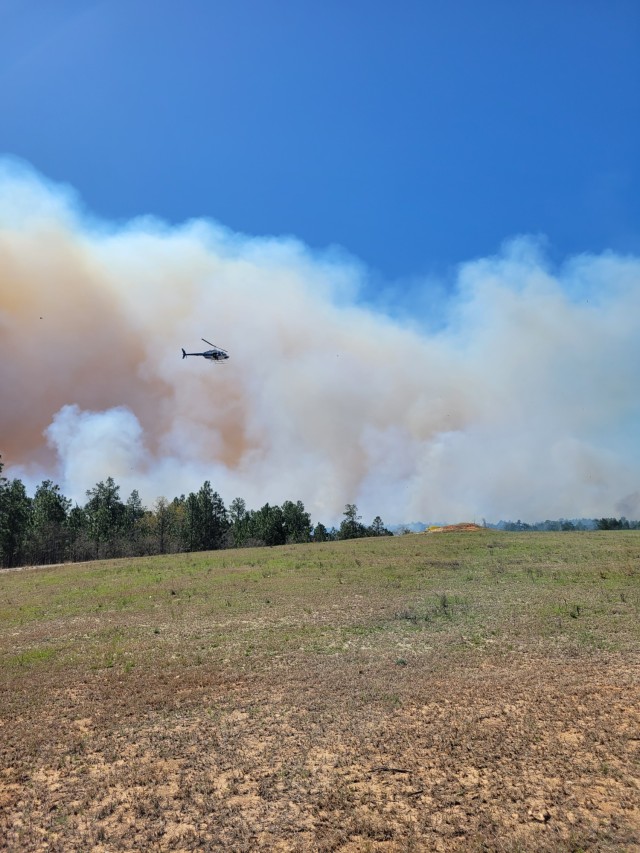 The Fort Stewart Directorate of Public Works Forestry Branch helicopter ignites an Artillery Impact Area during a controlled burn on Fort Gordon. 