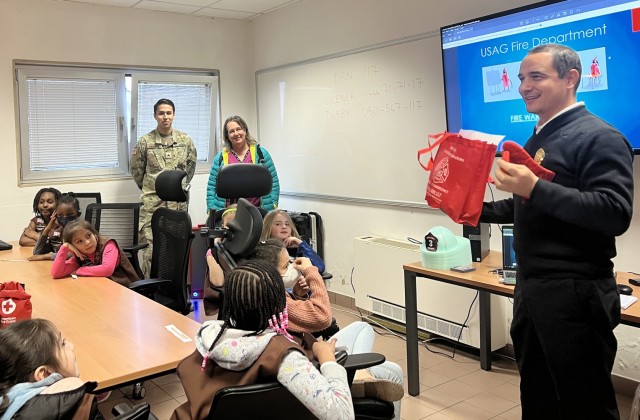 VICENZA, Italy – Luca Giaretta, battalion chief of Fire Prevention Office, Fire and Emergency Services for the garrison, talks about safety measures during the Vicenza Brownie Girl Scouts Troop #53 visit at the Fire Department Station on Caserma...