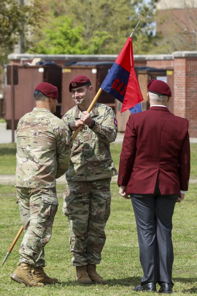 Lt. Col. Leif Thaxton, commander of Headquarters and Headquarters Battalion, 82nd Airborne Division, passes the guidon to Capt. Adam Johnson, commander of Gainey Company, Headquarters and Headquarters Battalion, 82nd Airborne Division during the uncasing ceremony of Gainey Company on Fort Bragg, N.C., March 29, 2023. The uncasing ceremony will allow for the company to unveil their guidon and formally begin operations. (U.S. Army photo by Spc. Lilliana Magoon)