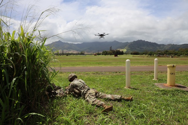 SCHOFIELD BARRACKS, Hawaii – 2nd Lt. Joe Larouche, mission commander for the 11th Cyber Battalion’s Expeditionary Cyber-Electromagnetic Activities Team-01, calls for the movement of an unmanned aerial system with a Remote Access Drop Device toward a target location, during an Operational Readiness Assessment for the battalion here, March 30, 2023.