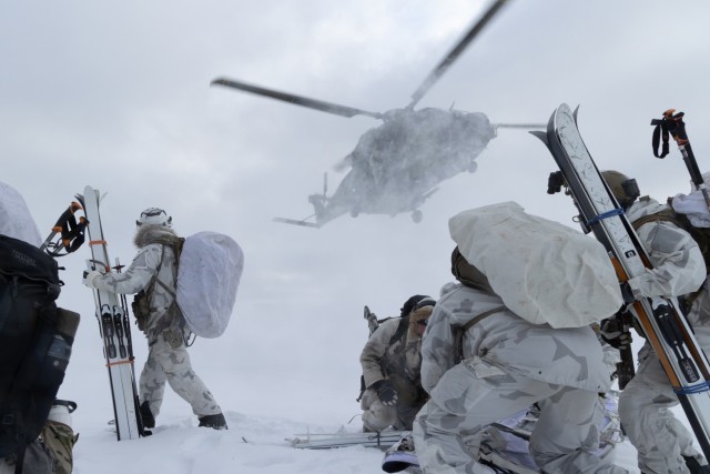 U.S. Army Green Berets with 10th Special Forces Group (Airborne) and Finnish Army special operations soldiers with Utti Jaeger Regiment posture on a helicopter landing zone in Lapland, Finland, March 12, 2023. The Utti Jaeger Regiment hosted Exercise Talvikotka 23 from March 12-16, 2023, inside the Arctic Circle to enhance and exchange winter warfare tactics and techniques.