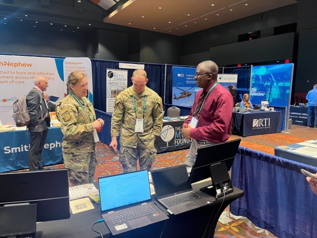 Mr. Kinnebrew, U.S. Army Medical Test and Evaluation Activity Test Officer, discussing testing of medical devices with military service members in attendance at Mr. Daniel Burrhus, U.S. Army Medical Test and Evaluation Activity Deputy Director, and Mr. Guy McSweeney, MTEAC Division Chief, briefing attendee of the 5th Annual Operational Medicine (OPMED) Symposium and Technology Showcase held March 28 through 29, 2023 at the Henry B. Gonzalez Convention Center, San Antonio, Texas.