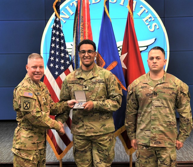 Spc. Vincent C. Tucci, an aviation operations specialist at 1st Battalion, 212th Aviation Regiment, stands with Maj. Gen. Michael C. McCurry, U.S. Army Aviation Center of Excellence and Fort Rucker co