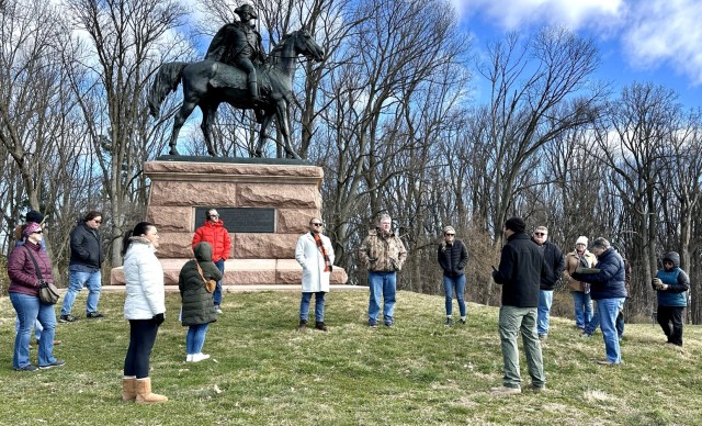 Don Bloss, a mentee in the USASAC mentor program, gives a briefing on the conditions and logistical challenges at Valley Forge, with a statue of Pennsylvania Brig. Gen. “Mad” Anthony Wayne in the background.