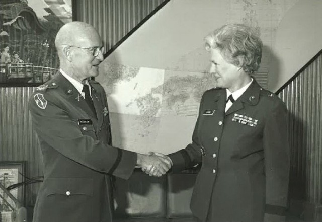 Col. David B. Hannum Jr., left, shakes hands with the director of the Women&#39;s Army Corps during her visit to Camp Zama, Japan, March 21, 1977. The U.S. Army Garrison Japan headquarters building was renamed in honor of Hannum, who previously served as commander of U.S. Army Garrison Honshu, during a ceremony April 5, 2023.