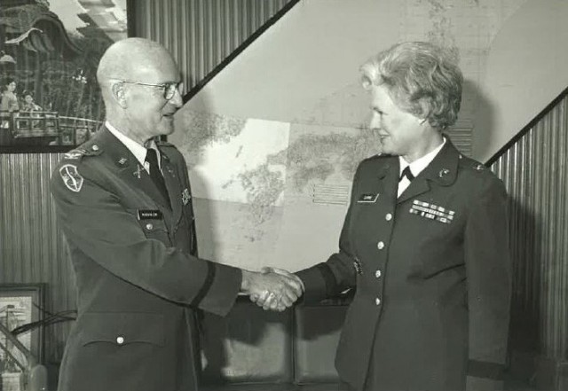 Col. David B. Hannum Jr., left, shakes hands with the director of the Women&#39;s Army Corps during her visit to Camp Zama, Japan, March 21, 1977. The U.S. Army Garrison Japan headquarters building was renamed in honor of Hannum, who previously...