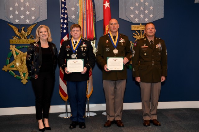 Staff Sgt. Zachary Olson and Sgt. 1st Class Antoni Bukowski are presented the Meritorious Service Medal during the Secretary of the Army Career Counselor of the year award ceremony at the Pentagon, Arlington, Va., March 31, 2023. Secretary of the...