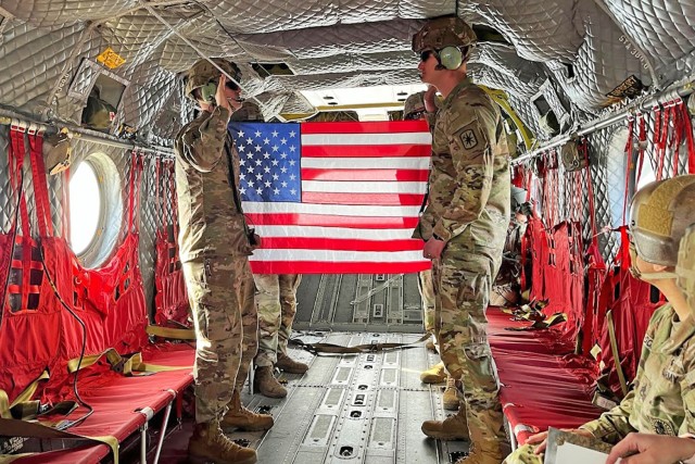 Capt. Jonathan Morton (left), commander of Company D, 795th Military Police Battalion, reenlists one of his drill sergeants, Staff Sgt. Chase Stevens, aboard a CH-47 Chinook helicopter on Tuesday over Fort Leonard Wood. The Chinook, from New...