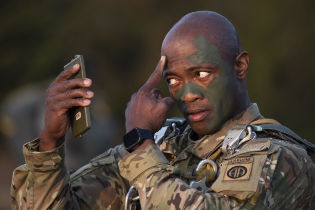 Sgt. 1st Class Demetrius Scrivens, with the 37th Brigade Engineer Battalion, at Fort Bragg, North Carolina, applies camouflage face paint Tuesday morning near Forney Airfield during the Operation Steel Box training exercise here this week. About...