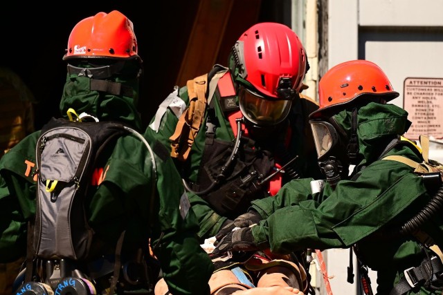 Search and extraction team members including U.S. Air Force Tech. Sgt. Samuel Marchini, center, of the 144th Medical Detachment, 144th Fighter Wing, California Air National Guard, and Spc. Karen Noyes, right, a heavy equipment construction...