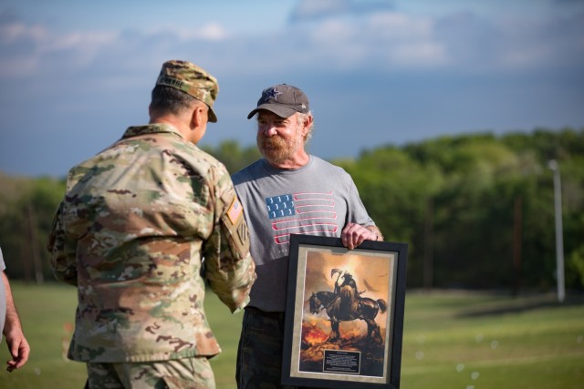 Lt. Gen. Sean Bernabe, III Armored Corps and Fort Hood commanding general, presents John Ryan of the Ryan Foundation with a special gift to commemorate the foundation&#39;s support of the Ben Hogan Classic March 31 at Fort Hood, Texas. (U.S. Army...