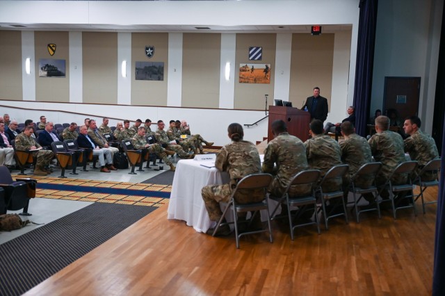 A multinational panel of military members from the United States Army, United Kingdom Army, and the Netherlands Army, ranging in rank from major to lance corporal, speaks with military members and industry vendors at the Army Expeditionary Warfare Experiment insights day April 4, 2023.  