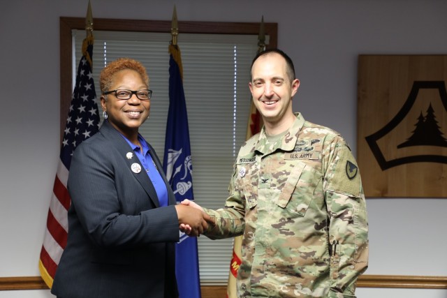 Roberta Sheffield with the Joint Culinary Center of Excellence at Fort Lee, Va., shakes hands with Fort McCoy Garrison Commander Col. Stephen Messenger on March 31, 2023, at the Fort McCoy, (Wis.) Garrison Headquarters following the completion of...