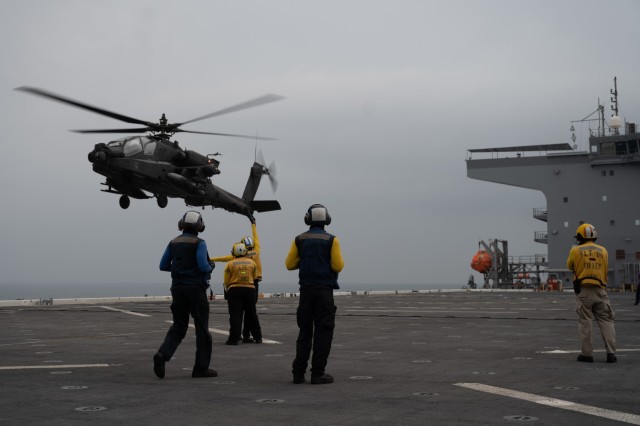 Task Force Rough Riders, Task Force Spartan, participate in amphibious operations and deck landing qualification on the expeditionary sea base USS Lewis B. Puller (ESB 3), in the Arabian Gulf, Nov. 10, 2022. Both UH-60 Blackhawks and AH-64 Apaches...