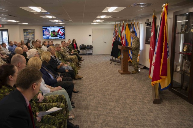 Brig. Gen. Brad Nicholson, Commanding General, United States Army Security Assistance Command, spoke during a dedication ceremony in memory of Capt. Michael Aucoin, Royal Canadian Forces, Logistics Service/Army Branch on April 4, 2023 in New Cumberland, Pennsylvania. Aucoin passed away while on assignment to USASAC in 2011. USASAC honors Cpt. Aucoin with the naming of a conference room after him.