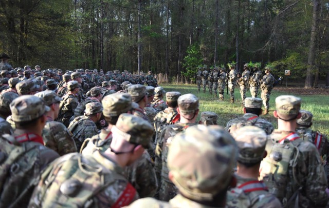 Infantry recruits with Bravo Company, 1st Battalion, 50th Infantry Regiment, observe the Hooah squad during the First 100 Yards at Fort Benning, Georgia, March 30, 2023. The 90-minute event teaches new recruits how to quickly work together to accomplish the mission. 