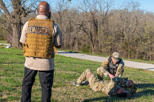 Joffree Gilliard, from Installation Management Command-Pacific, evaluates Sgt. Louis Guardado, a military policeman with the Directorate of Emergency Services, as he responds to a mock injured Soldier during an active-shooter scenario on Tuesday...