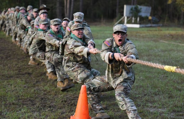 Infantry recruits with Bravo Company, 1st Battalion, 50th Infantry Regiment, compete in a tug-or-war competition during the First 100 Yards at Fort Benning, Georgia, March 30, 2023. The 90-minute event teaches new recruits how to quickly work together to accomplish the mission. 