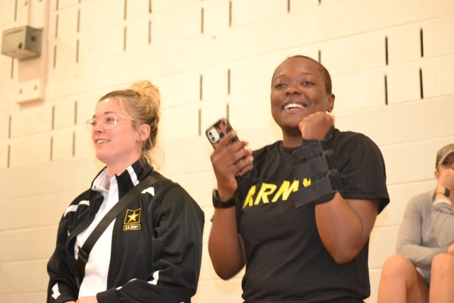 Amber Strittmatter (left) is all smiles cheering on Soldier Athletes alongside Sgt. (right) Kaylin McClendon in power lifting at the 2023 Army Adaptive Sports Camp.