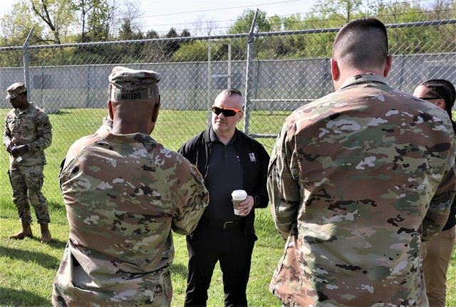 Fort Knox Garrison Command Sgt. Maj. Sherman Waters speaks with members of the 905th Military Working Dog team and John Troxell, a former Fort Knox command sergeant major and Senior Enlisted Advisor to the Chairman of the Joint Chiefs of Staff, during Troxell’s visit to Fort Knox April 19, 2023.
