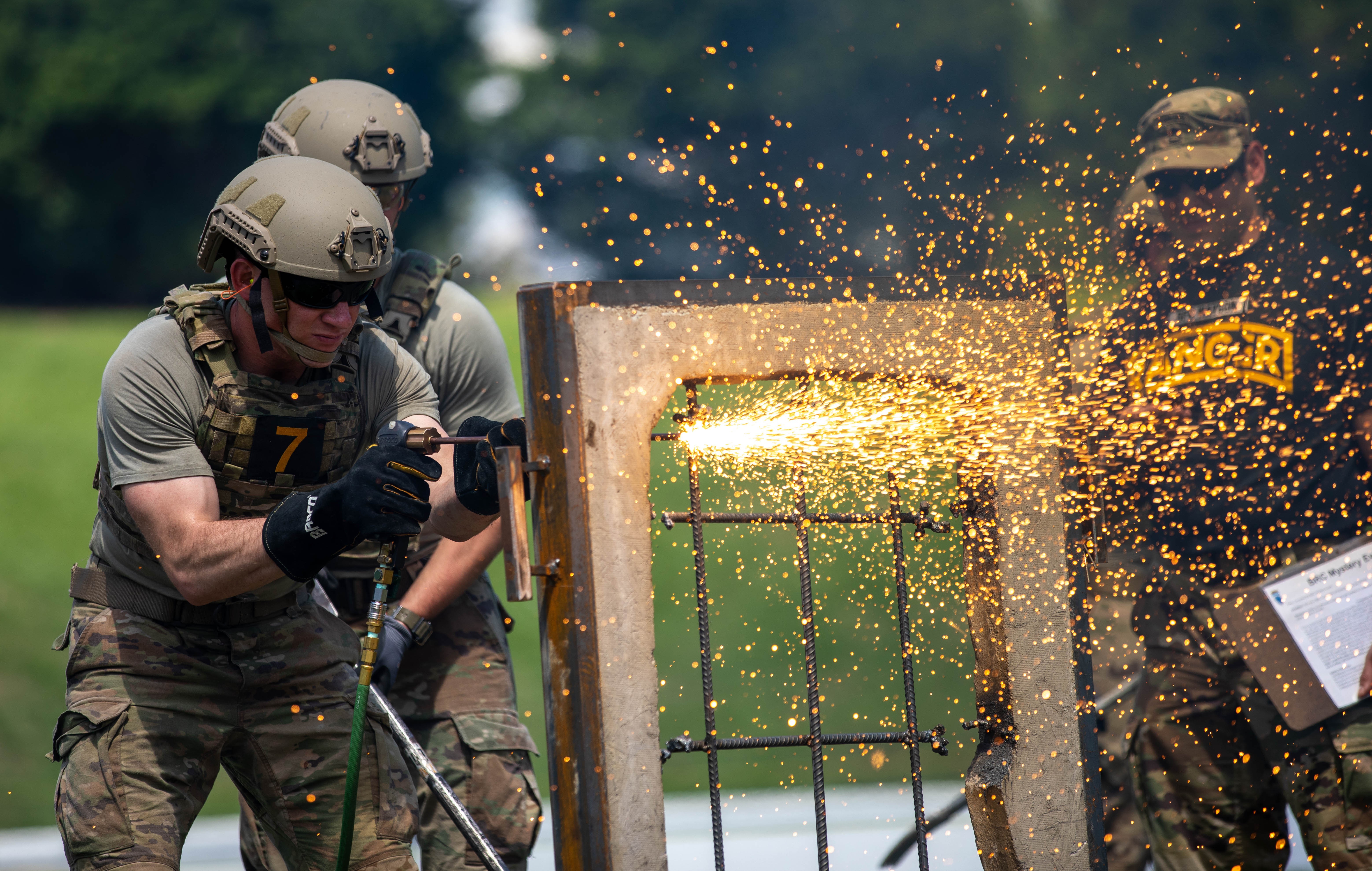 Capt. Aaron Dominic, a Soldier assigned to the 2nd Battalion, 23rd Infantry Regiment, 1st Stryker Brigade Combat Team, 4th Infantry Division cuts through an obstacle designed to simulate a steel-reinforced window during the Best Ranger Competition at Columbus, Georgia, on April 15, 2023. The Best Ranger Competition is held annually at Fort Benning, Georgia, where for over 60 hours, ranger-qualified soldiers compete in a series of challenges ranging from physical fitness, technical capabilities, and marksmanship.