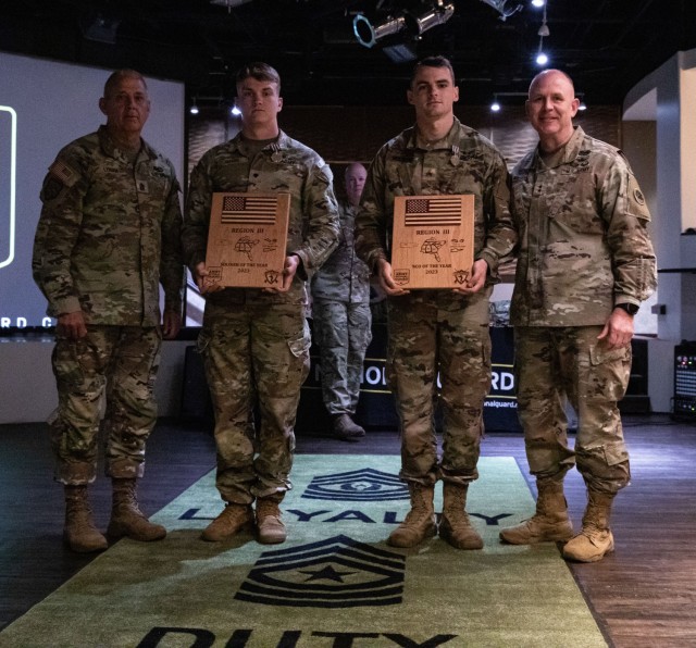 U.S. Army Spc. Jackson Jacobs, left holding plaque, an artillery forward observer representing the Tennessee Army National Guard, and Sgt. Quentin Holden, right holding plaque, a UH-60 helicopter crew chief representing the Georgia Army National Guard, are nominated the Best Warrior and Noncommissioned Officer of the 2023 Region III Army National Guard Best Warrior Competition at Fort Stewart, Georgia, April 21, 2023. They will go on to compete at the 2023 National Army National Guard Best Warrior Competition against the winners in the four other regions at Joint Base Elmendorf-Richardson, Alaska, July 6-15, 2023. (U.S. Army photo by Sgt. Kinsey Geer)