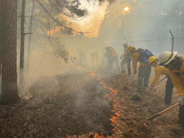 Students dig the line and hold a burnout during the annual Wildland Fire Academy held at Red River Army Depot.