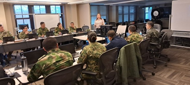 Vanessa Lugo, country program manager for SOUTHCOM/NORTHCOM, teaches international students about the foreign military sales process,
